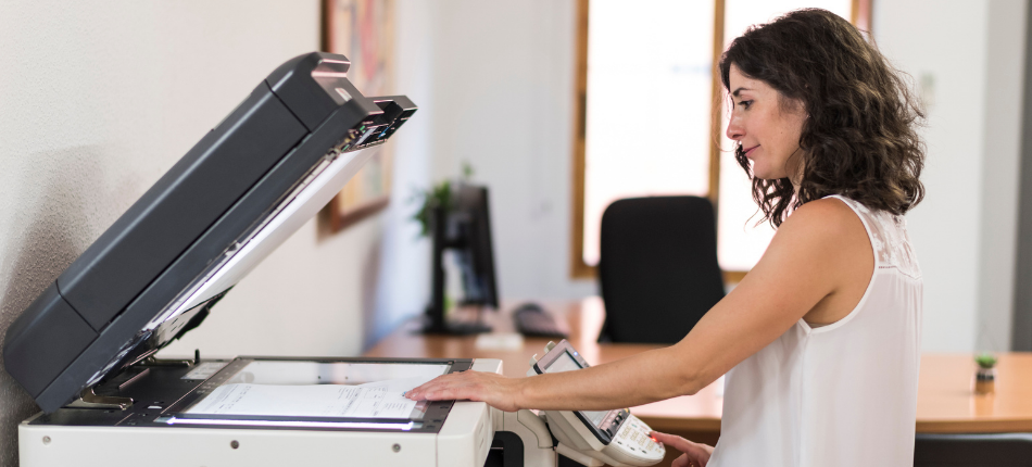 A woman operating office copiers